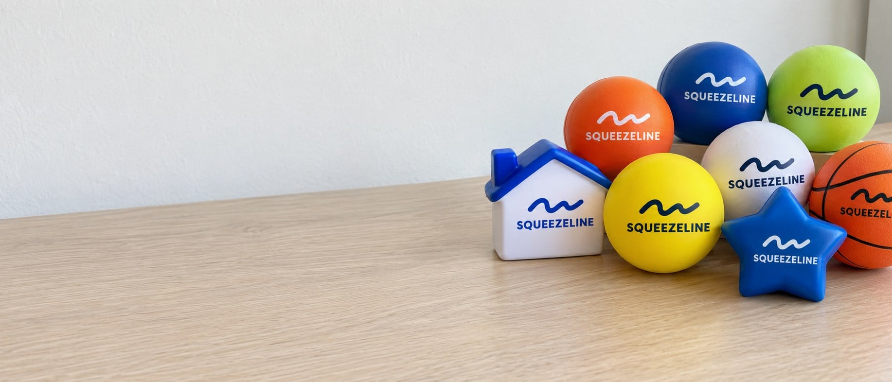 Custom printed stress balls in bright colors on an office desk